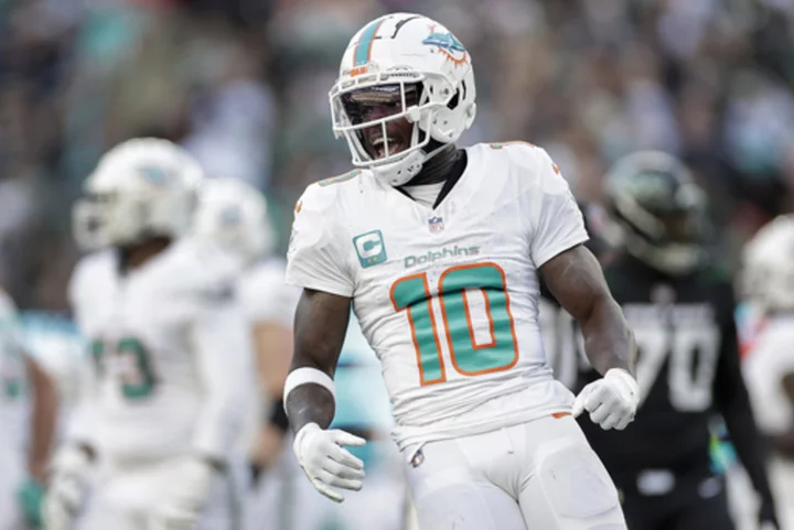 Hill's special TD catch and Holland's 99-yard INT return lead Dolphins past Jets 34-13