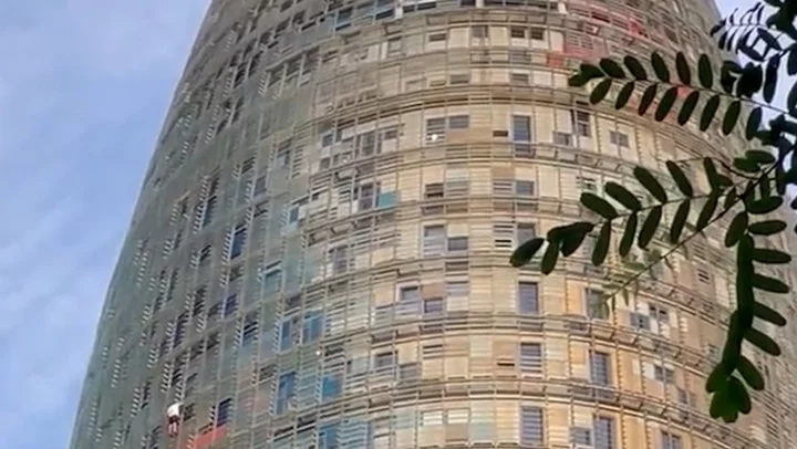 Climbers scale 142-metre tall tower in Barcelona city centre