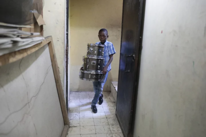 Haitian students play drums and strum guitars to escape hunger and gang violence