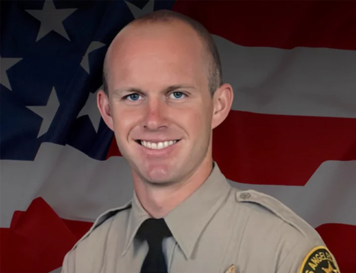 Los Angeles County sheriff's deputy dies after being shot in his patrol car by an unknown assailant