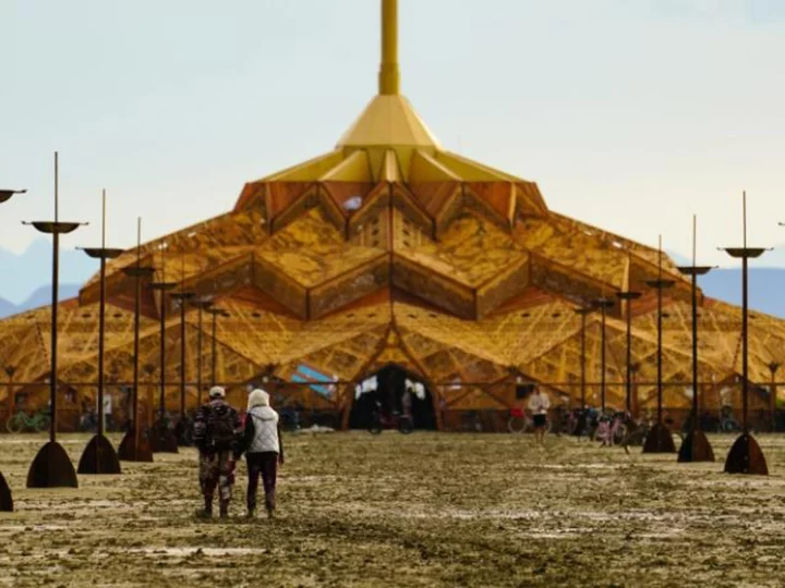 Burning Man attendees are still stranded in ankle-deep mud after heavy rains force road closures in the Nevada desert