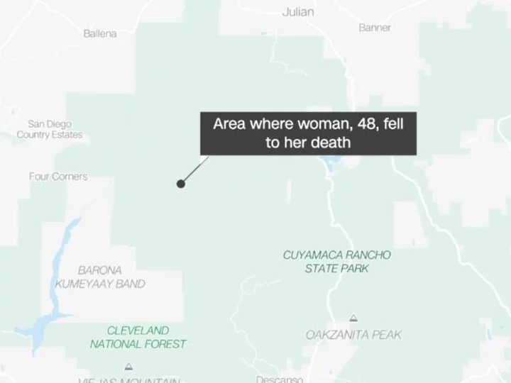 A California woman fell to her death at a popular hiking area while trying to rescue a teenage girl who slipped, authorities say