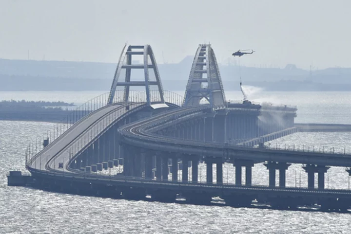 Traffic on key bridge from Crimea to Russia's mainland halted amid reports of explosions and deaths