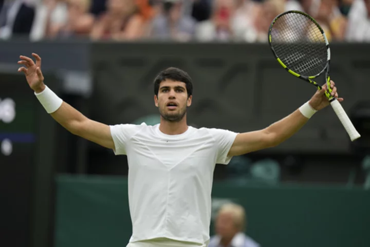 At rainy Wimbledon, Alcaraz among those playing day after day -- and winning