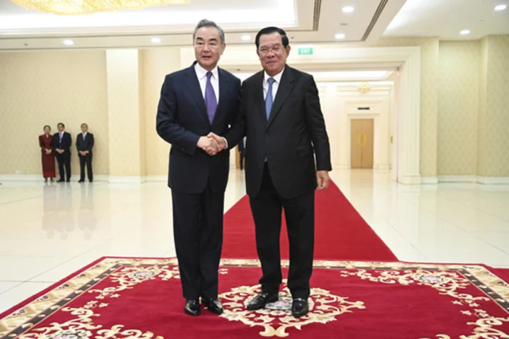 China's foreign minister visits Cambodia days after incumbent premier hands off the job to his son